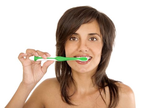 Young woman brushing her teeth on white background