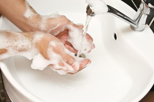 close-up of washing hands with water and soap