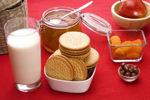 Delicious breakfast foods over red fabric background