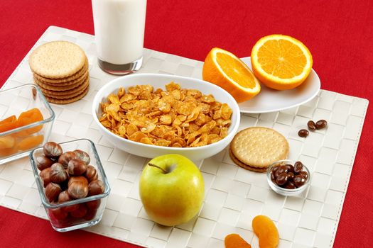 Delicious breakfast foods over red fabric background