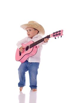 Cute little boy holding a guitar