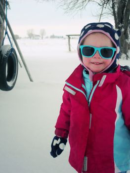 Toddler girl playing in the snow