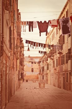 Old Venetian yard, Italy.Photo in old color image style.