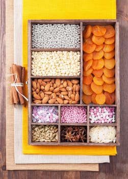 Ingredients for baking in a wooden box on the background of linen napkins and wood