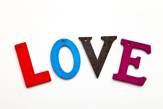 love word formed with colorful letter on neutral background