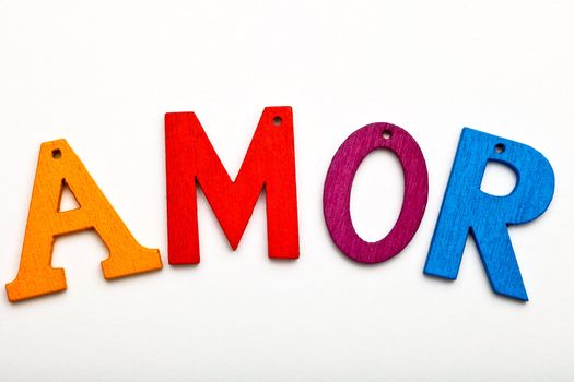 Amor word formed with colorful letter on neutral background