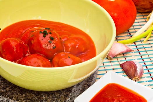 Bowl with meatballs and tomato sauce
