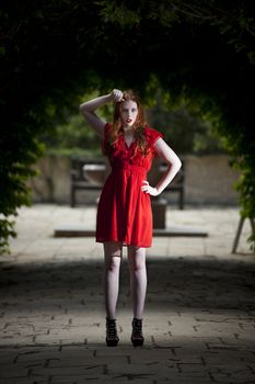 Young woman in red dress looking direct at viewer