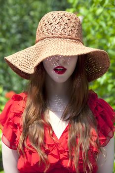 Young woman fith face covered by hat only showing beautiful lips