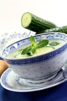 cold cucumber soup with slices of cucumber and mint