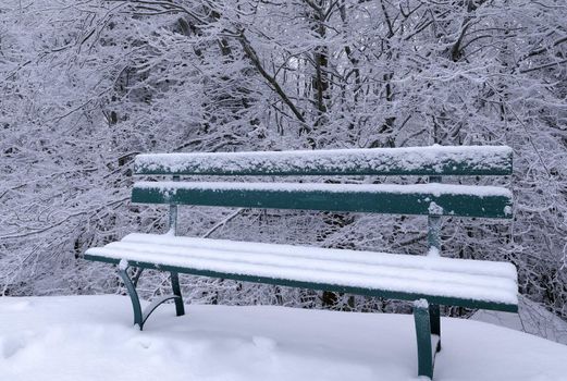 a bench covered with snow