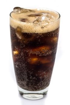 cola with ice on the grass