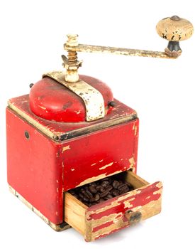 vintage coffee grinder with coffee on white background