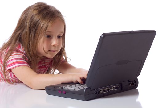 Cute little girl siting with a laptop