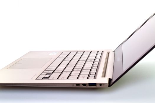 a modern metal-fnished laptop with opened lid against white background for abstract background