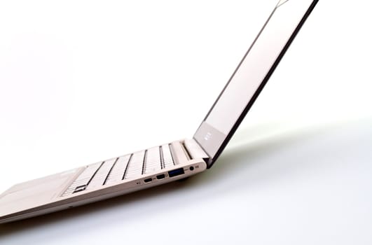 Side view of an ultrathin modern laptop against white for abstract and background