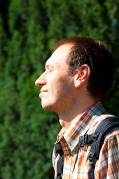 Man on a background of green foliage