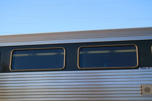 Passenger train parked at a train yard.
