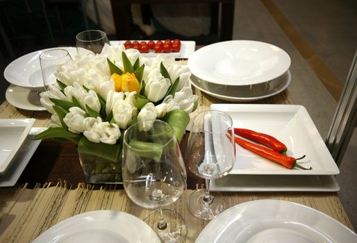The served table at restaurant with bouquet