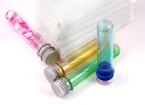 White towels and four bottles with shampoo