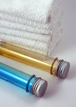 White towels and two bottles with shampoo