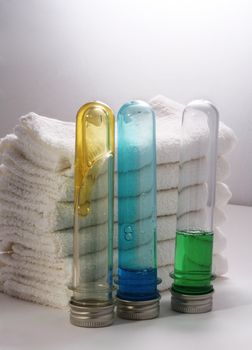 White towels and three bottles with shampoo
