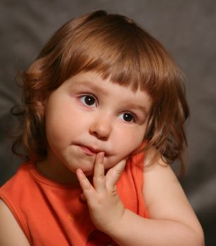 Portrait of the two-year-old girl with an amusing grimace