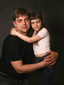 Double portrait. The daughter embraces the father