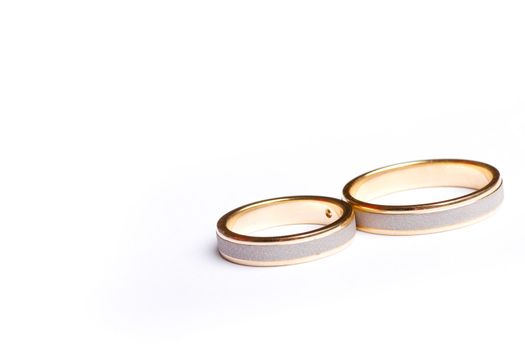 Pair of wedding bands isolated on white background, macro