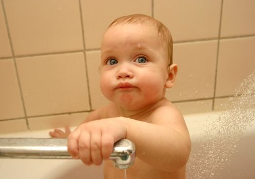 The little child taking a bath 