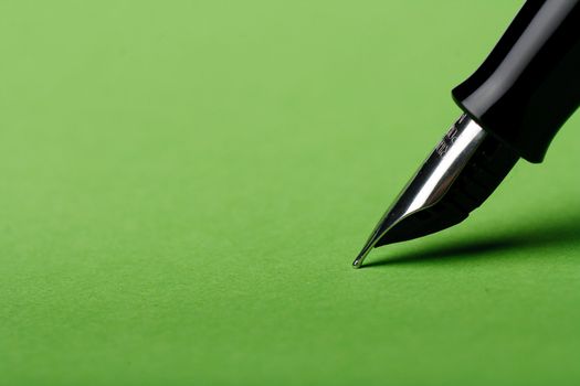 Macro isolated fountain pen on green background