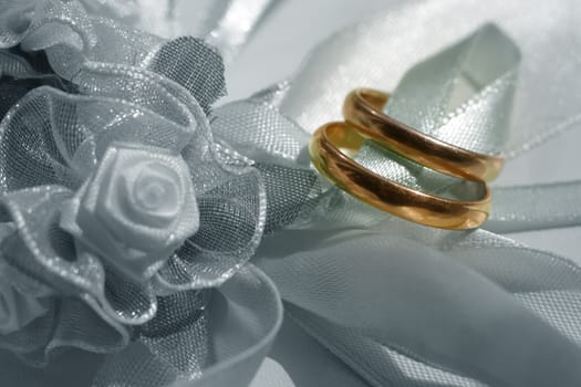 Wedding rings on a satiny tape. selective color wedding rings