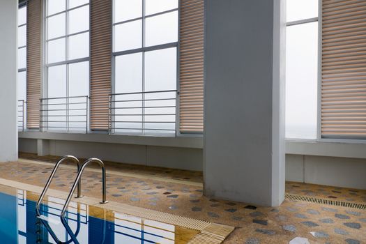 Indoor Swimming pool, stainless steel railing and large window