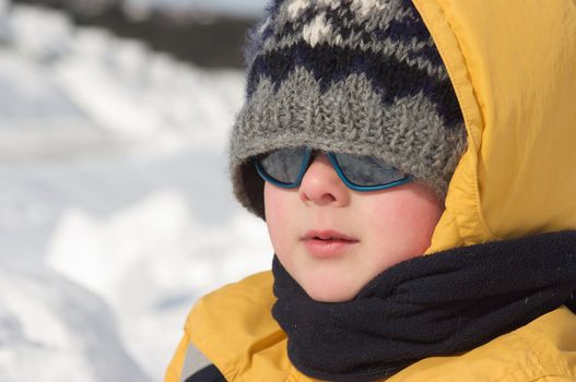 Cute little boy playing in the snow