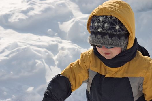 Cute little boy playing in the snow