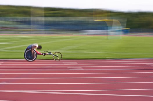 Black athlete racing in a wheelchair on a track