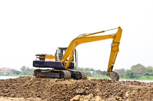 Backhoe machine during excavation soil works outdoors at construction site.