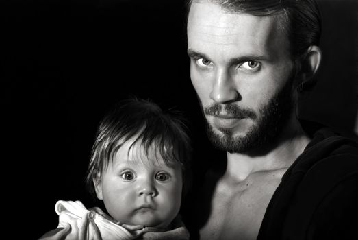 Beautiful black and white portrait of a young father with his son. Nature noise