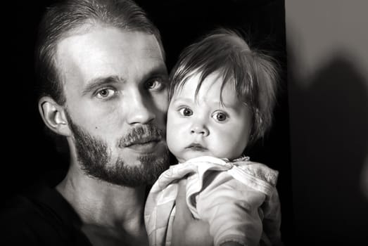 Beautiful black and white portrait of a young father with his son.