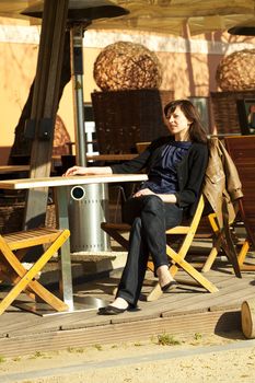 young woman sitting at a table in a cafe