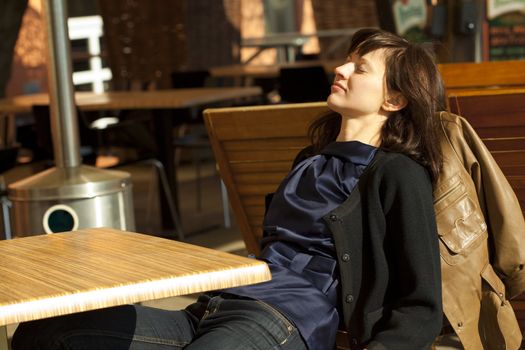 young woman sitting at a table in a cafe