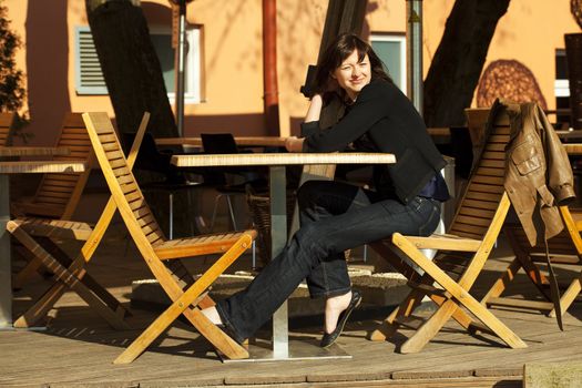 young woman sitting at a table in a cafe