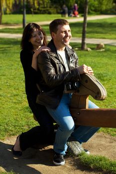 young couple in a baby swing