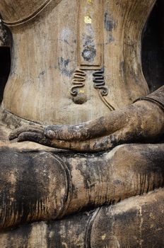 Detail of hand of stone sitting Buddha in Sukhothai historical park, Thailand