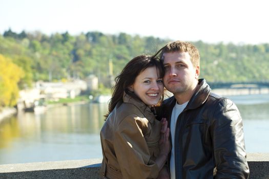 young couple on a bridge on the river