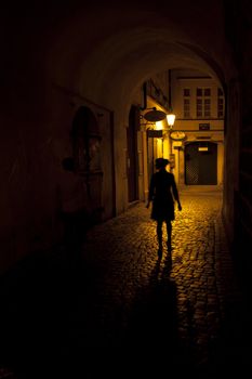 silhouette of a woman in an arch on the street