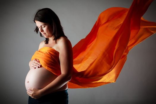 32 weeks pregnant woman with an orange veil
