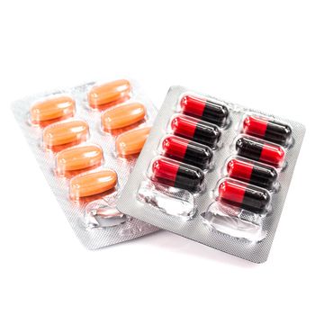 colorful capsules and pills closeup on white background