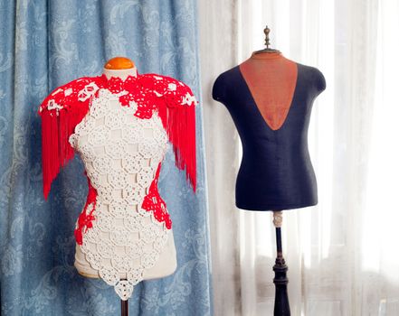 dressmakers and taylor mannequin with fashion clothes and curtain background