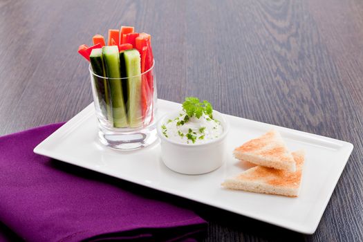 fresh vegetables snack and cream cheese dip with bread on plate